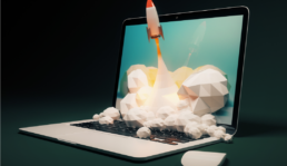 Startup concept with rocket flying out of laptop screen on black background